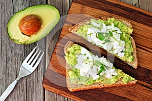 Avocado toast with egg whites and pea shoots, overhead view