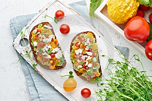 Avocado toast with feta and tomatoes, smorrebrod with ricotta, top view photo