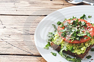 Avocado toast. Healthy toast with avocado mash and tomatoes on a plate