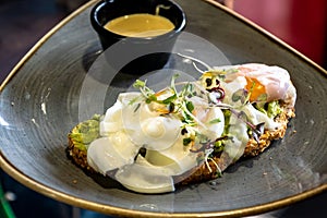 avocado toast with poached eggs and hollandaise sauce.