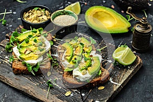 Avocado toasts with rye bread, Delicious breakfast or snack, Clean eating, dieting, vegan food concept. top view