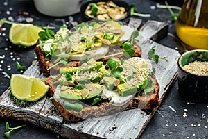 Avocado toasts with rye bread, Delicious breakfast or snack, Clean eating, dieting, vegan food concept. top view
