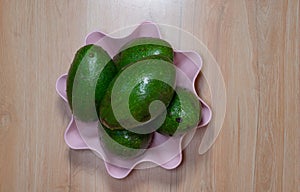 Avocados fruit on the wood table with pink wall background part 4