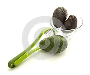 Avocados in glass bowl with slicer photo