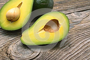 Avocados one cut in two with seed photo