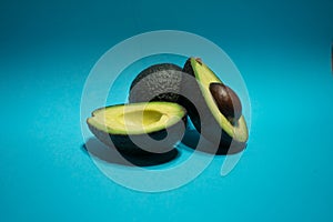 Avocados presented on light blue background