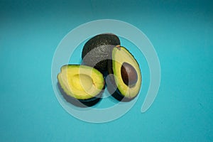 Avocados presented on light blue background