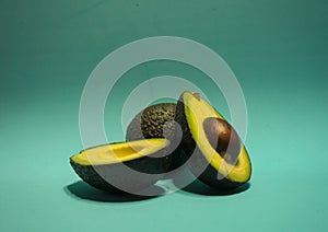 Avocados presented on turquoise background