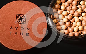 Avon glow bronzing pearls isolated on dark background.