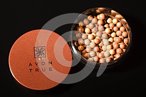 Avon glow bronzing pearls isolated on dark background.