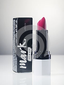 Avon lipstick isolated on gradient background.