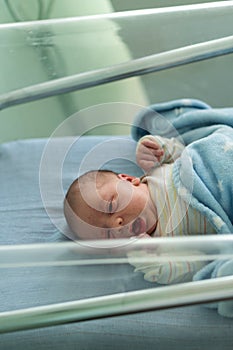 Awake Newborn Baby Face Portrait Acne Allergic Irritations Early Days Grimace Crying On Blue Background. Child Start