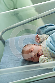 Awake Newborn Baby Face Portrait Acne Allergic Irritations Early Days Grimace Crying On Blue Background. Child Start