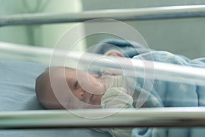 Awake Newborn Baby Face Portrait Acne Allergic Irritations Early Days Grimace Crying On Blue Background. Child Start