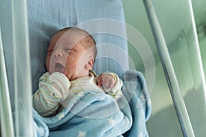 Awake Newborn Baby Face Portrait Acne Allergic Irritations Early Days Grimace Crying On Blue Background. Child Start