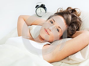 Awake young woman in her bed