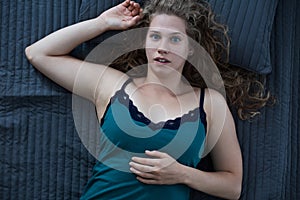 Awaken woman lying in bed photo