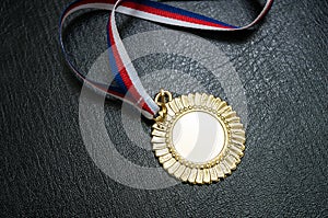 Award for a winner - gold medal on black background photo