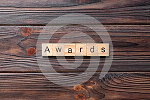 AWARDS word written on wood block. AWARDS text on cement table for your desing, concept