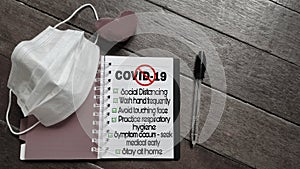 awareness concept - text covid-19 with stop sign and tips note written on notepad