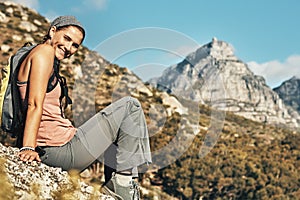 Away from it all, and I couldnt be happier. Portrait of a young woman taking a break while out on a hike through the