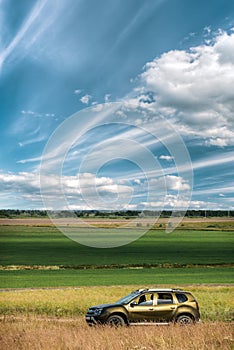 AWD 4WD SUV green car in summer meadow landscape