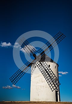 Awe old windmill with blue sky at sunset