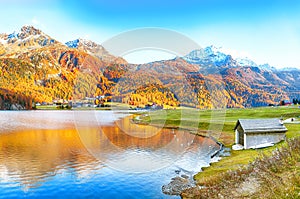 Awesome autumn panorama of Silvaplana lake and Surlej village