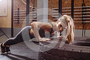 Awesome blonde doing the exercise on the tire