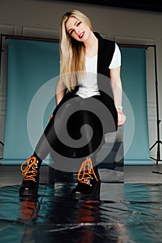 Awesome caucasian attractive professional female model with blond hair posing in studio.