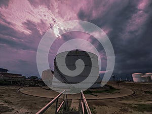 Awesome cloudy sky with a storagetank.