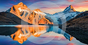 Awesome evening panorama of Bachalp lake Bachalpsee, Switzerland. Unbelievable autumn sunset in Swiss Alps, Grindelwald, Bernese