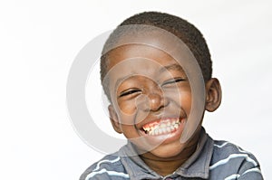 Awesome huge smile on black African ethnicity black boy child isolated on white Portrait