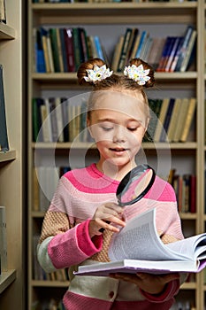 awesome little girl in casual wear in library after school