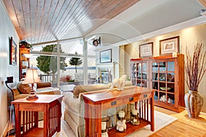 Awesome living room interior with sloped wooden ceiling.