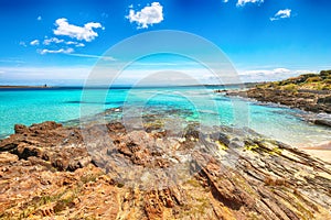 Awesome morning view of Famous La Pelosa beach and rocky shore near Torre della Pelosa