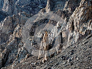 Awesome scenic mountain landscape with big cracked pointed stones closeup in sunlight. Sharp rocks background