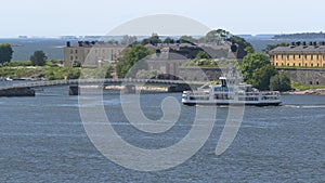 Awesome shot of a ferry sailing near the coastal islands of Helsinki.