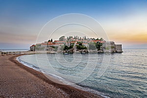 Awesome sunset, famous island Sveti Stefan in Adriatic sea at Montenegro