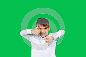 Awesome toddler boy shows like and dislikes to the camera on green background