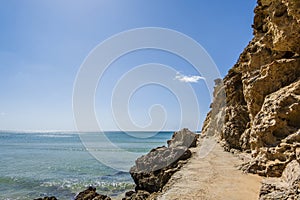 Awesome view of Albufeira cliff with side walk, Fisherman Beach, Praia dos Pescadores, Albufeira, Algarve, Portugal photo