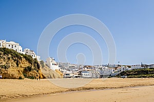 Awesome view of Albufeira whitewashed houses on cliff, Praia dos Pescadores, Albufeira, Portugal photo