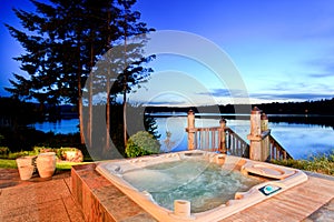 Awesome water view with hot tub at dusk in summer evening.