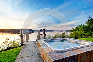 Awesome water view with hot tub at dusk in summer evening.