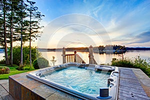 Awesome water view with hot tub in summer evening.