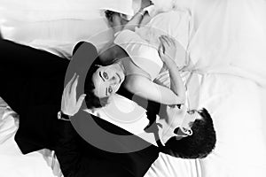 Awesome wedding couple rests on the white bed
