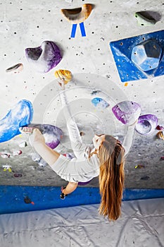 Awesome woman climbing indoor look up