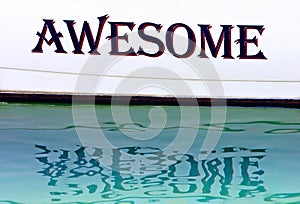 Awesome written on the side of a boat in Spain