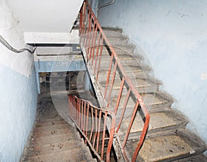 Awful and dirty interior of staircase in apartment building with cheap apartments