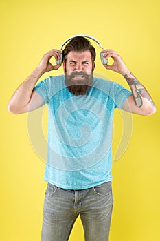 Awful sound. Hipster listen broken headphones music gadget. Hateful song. Music taste. Bearded guy dislike music